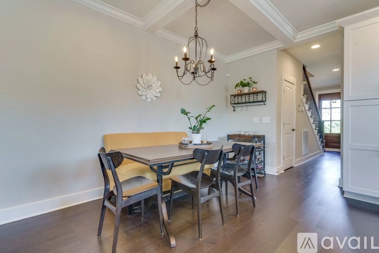 A dining room with a table and chairs.