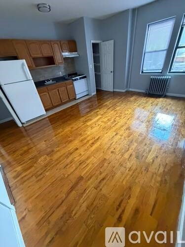 A kitchen with wooden floors and white appliances.