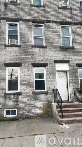 A brick building with the number 337 on the door.