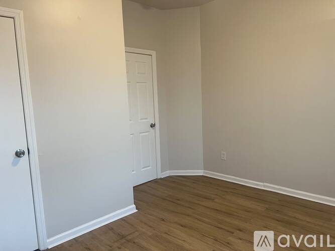A room with a white door and a white wall.