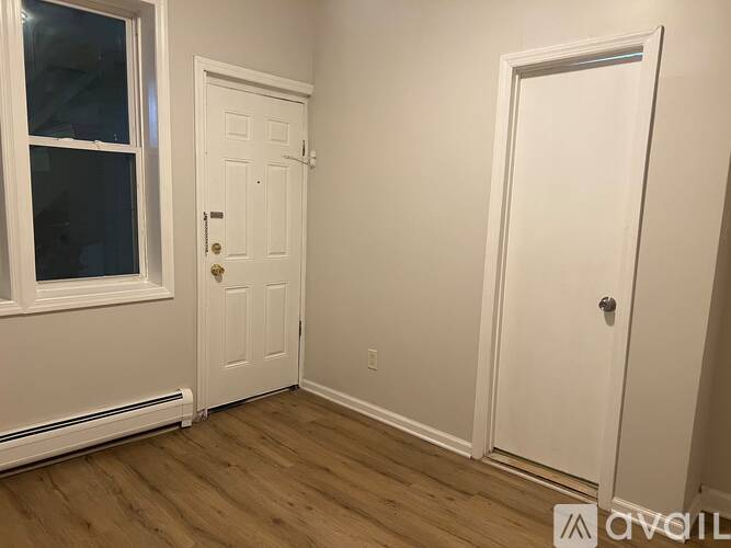 A white door with a silver handle is on the right side of the image.