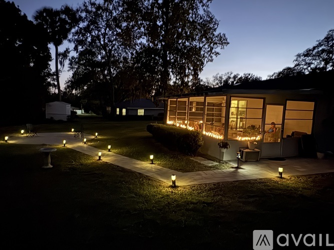A house is lit up with lights at night.