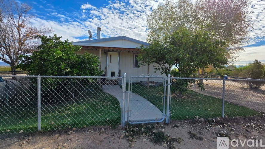 A house with a fence and a walkway leading to the front door.