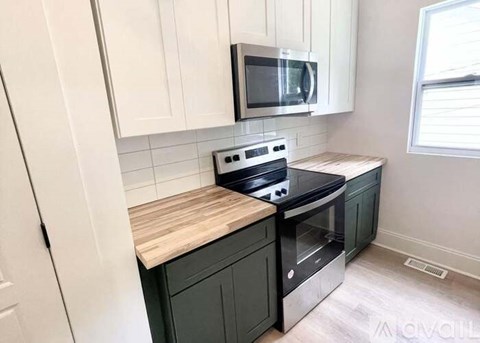 A kitchen with a stove top oven and microwave.