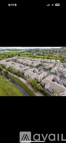 A bird's eye view of a residential area with houses and a river.