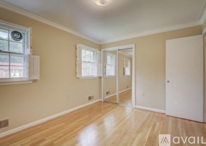 A room with wooden floors and a white door.