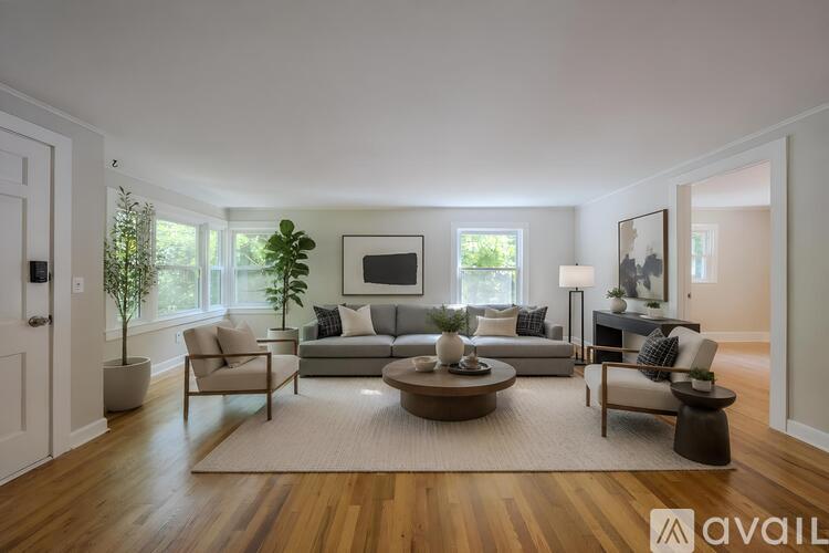 A living room with a couch, chair, and a coffee table.