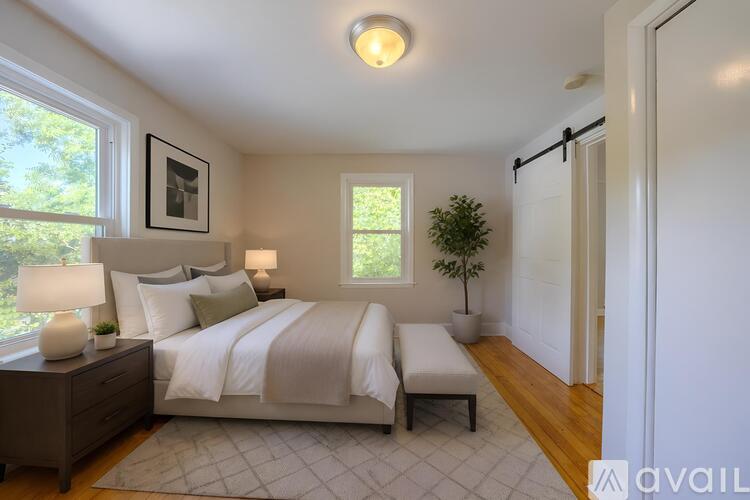A bedroom with a large bed and a window.