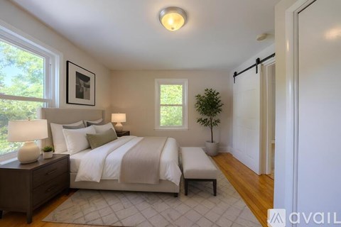 A bedroom with a large bed and a window.