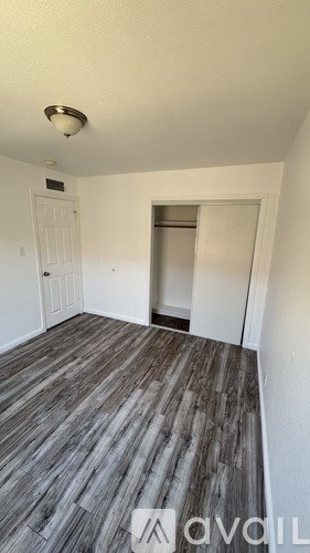 A room with a wooden floor and white walls.