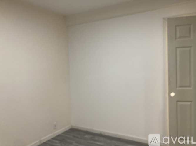 A room with a door and a tiled floor.