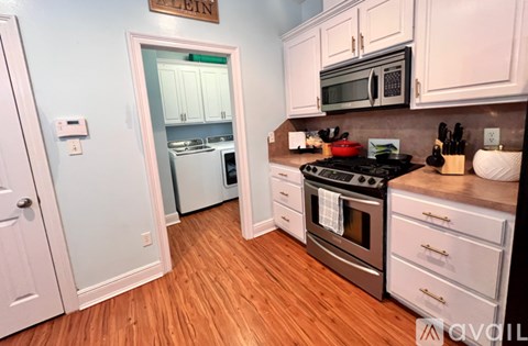 A kitchen with a stove top oven and a refrigerator.