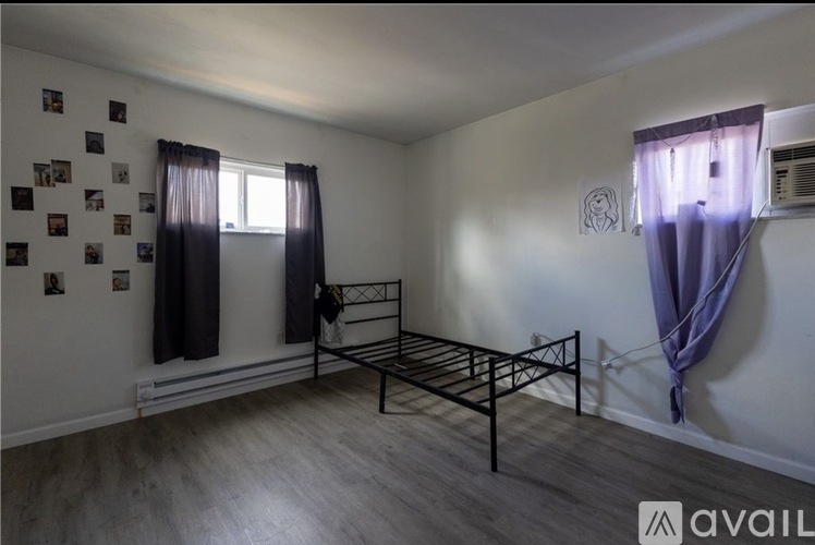 A room with a bed and pictures on the wall.