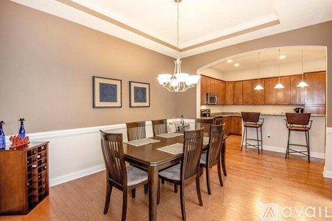 A dining room with a wooden table and chairs.