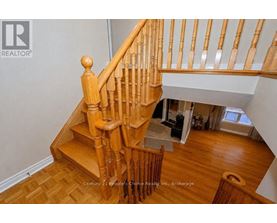 A wooden staircase with a white wall in the background.