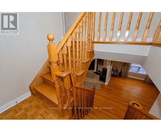 A wooden staircase with a white wall in the background.