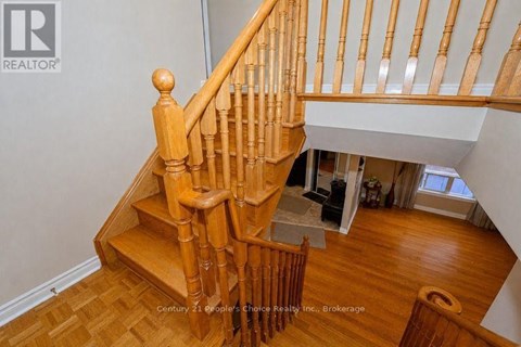 A wooden staircase with a white wall in the background.