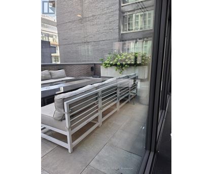 A balcony with a bench and a planter box.