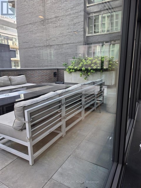 A balcony with a bench and a planter box.