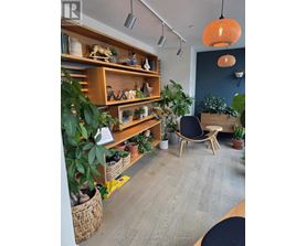 A room with a wooden shelf and a chair.
