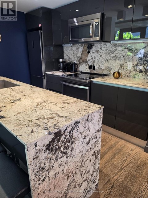 A kitchen with a granite counter top.