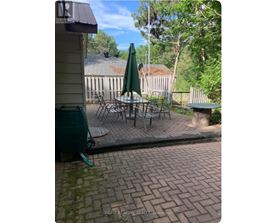 A patio with a table and chairs and an umbrella.