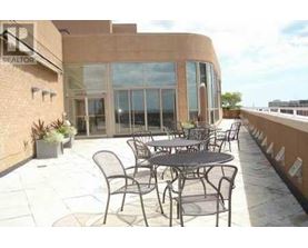 A patio with a table and chairs is in front of a building.