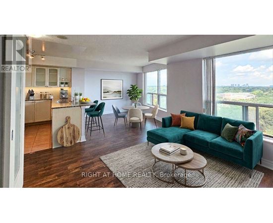 A living room with a green couch and a wooden floor.