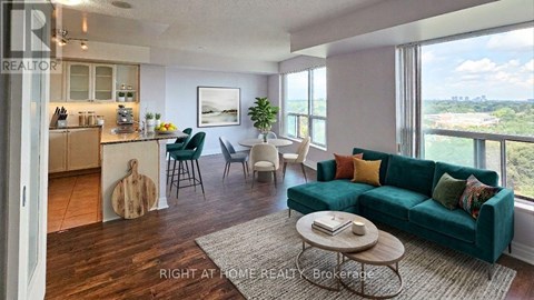 A living room with a green couch and a wooden floor.