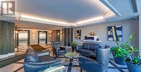 A living room with a couch, chairs, and a coffee table.