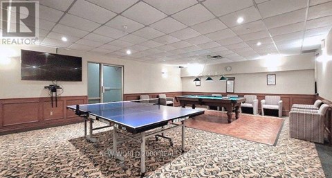A room with a pool table and a couch.