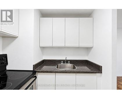 A kitchen with a sink and cabinets.