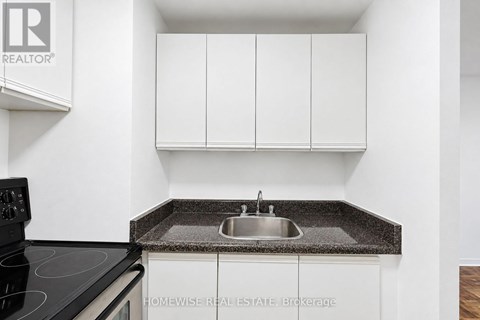 A kitchen with a sink and cabinets.