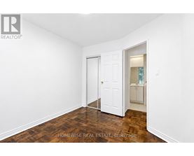 A room with a white door and a white wall.