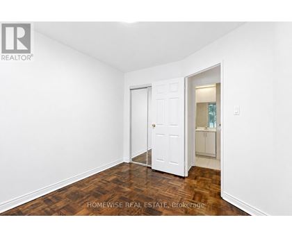 A room with a white door and a white wall.
