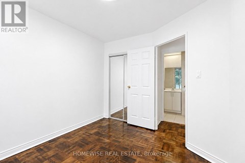 A room with a white door and a white wall.