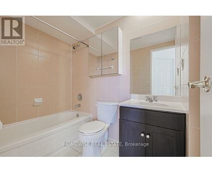 A bathroom with a toilet, sink, and bathtub.