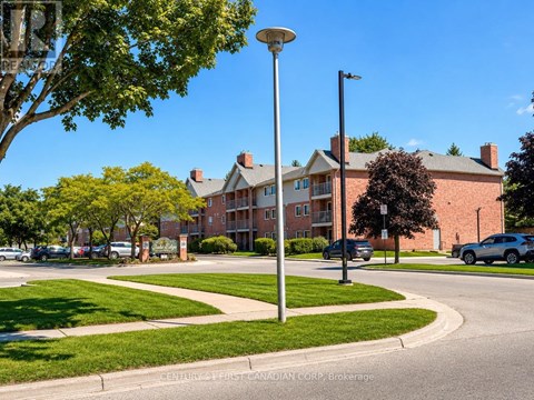 A street view of a residential area with apartment buildings and parked cars.