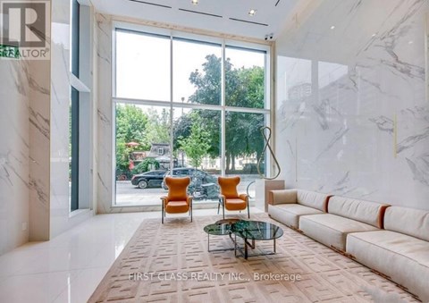 A living room with a glass table and two chairs.