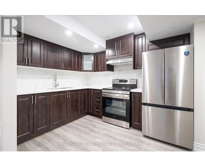 A kitchen with dark wood cabinets and stainless steel appliances.