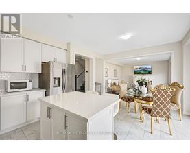 A modern kitchen with a dining table set for four.