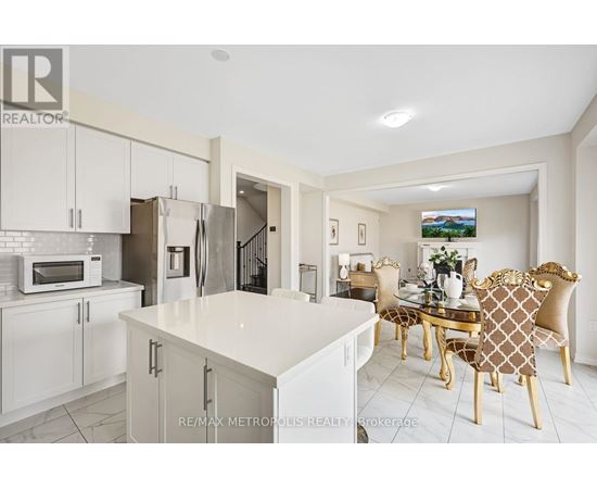 A modern kitchen with a dining table set for four.