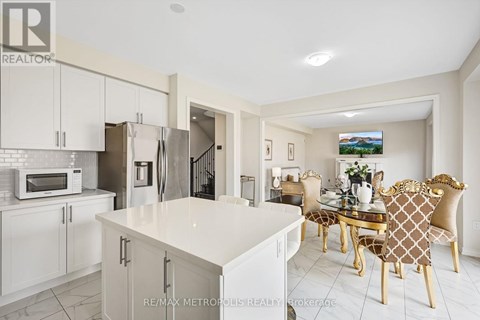 A modern kitchen with a dining table set for four.