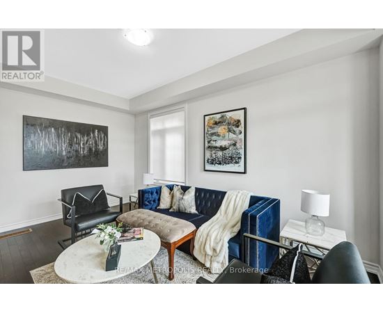 A living room with a blue couch and a coffee table.