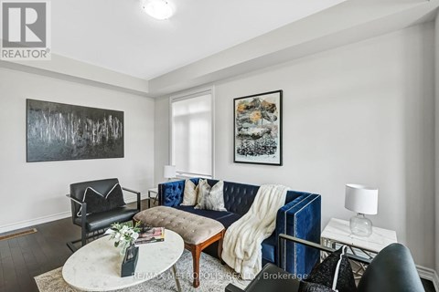 A living room with a blue couch and a coffee table.