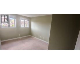 A room with a realtor logo on the wall.