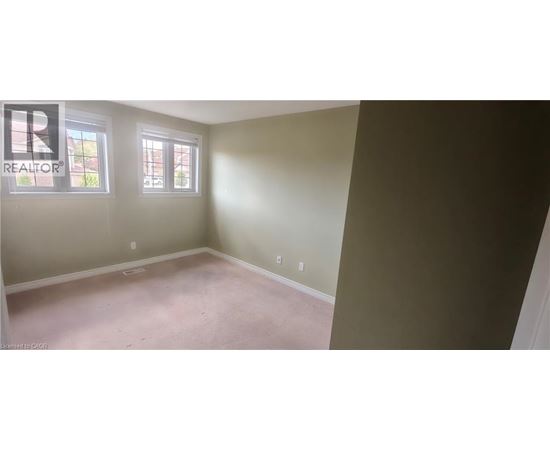 A room with a realtor logo on the wall.