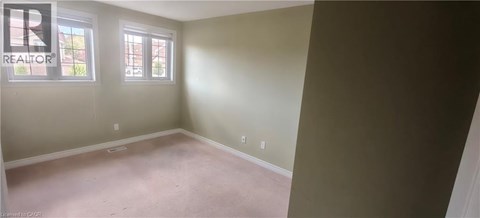 A room with a realtor logo on the wall.