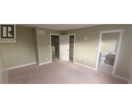 A room with a toilet in the doorway.