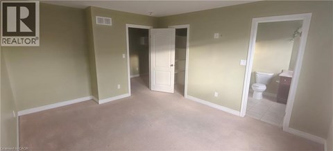 A room with a toilet in the doorway.